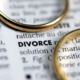 A close-up of the word DIVORCE in a dictionary with two wedding rings symbolising the financial complexities and need for accurate actuarial valuations in a maintenance calculation