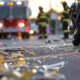 Debris on a South African road with an ambulance in the background, representing the high severity of road accidents that necessitate professional RAF claim valuations.