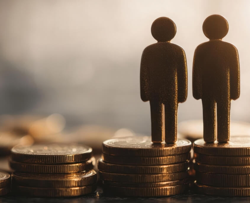 Figurines on coins representing the precise financial modeling used by an Actuarial Consultant to determine a maintenance calculation.